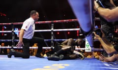 Referee Kieran McCann gives Deontay Wilder a 10-count after he was knocked down in the fifth round early Sunday morning in Riyadh. 