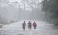 Rescue workers wade through a tidal surge after the Steinhatchee River flooded in Florida on 30 August 2023 following the arrival of Hurricane Idalia.