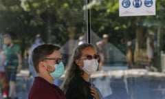 People wearing masks to prevent the spread of COVID-19, ride the little train of the Chateau de Versailles