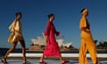 Models walk the runway with the Sydney Opera House in the background during the Bondi Born show at Australian fashion week
