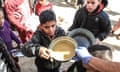 Volunteers of World Central Kitchen hand out food to Palestinian children in the mobile kitchens they have brought to Rafah, Gaza.