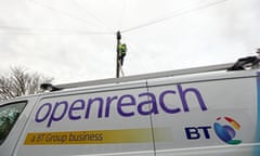 A network engineer from Openreach climbs a telegraph pole to carry out maintenance work with a van in the foreground