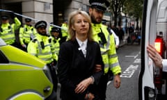Police officers detain co-founder of the Extinction Rebellion group, Gail Bradbrook.