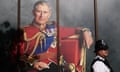 A police officer walks past an image of King Charles in London