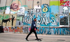A Palestinian walks past the separating wall in Bethlehem.