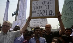 Bangladeshi activists and relatives of the victims of the Rana Plaza building collapse take part in a protest marking the first anniversary of the disaster at the site where the building once stood in Savar on the outskirts of Dhaka on April 24, 2014. The Rana Plaza building collapsed on April 24, 2013, killing 1138 workers in the world’s worst garment factory disaster. Western fashion brands faced pressure to increase help for victims as mass protests marked the anniversary. Thousands of people, some wearing funeral shrouds, staged demonstrations at the site of the now-infamous Rana Plaza factory complex. AFP PHOTO / Munir uz ZAMANMUNIR UZ ZAMAN/AFP/Getty Images