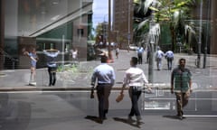 Office workers reflected in a Sydney CBD window