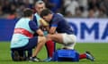 France’s Antoine Dupont receives treatment after taking a knock to the head against Namibia