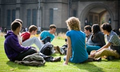 StudentsStudents sat on lawn outside university building
