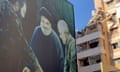 A poster showing the late Hezbollah military commander Imad Mughniyeh, left, Hezbollah leader Sayyed Hassan Nasrallah, center, and the late Revolutionary Guard Gen. Qassem Soleimani is set near a damaged building