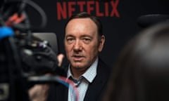 Kevin Spacey in front of Netflix logo sign