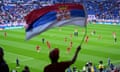 A Serbia supporter waves a flag before his team’s Euro 2024 group game against England at the Arena AufSchalke on Sunday