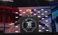 man with arms outstretched speaking at a podium