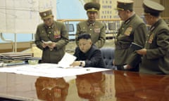 Kim Jong-un discussing military strategy on the peninsula with his generals.