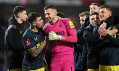 Bruno Guimaraes and Martin Dubravka of Newcastle United celebrate following the penalty shootout win over Blackburn.