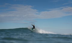 woman in wetsuit riding a wave