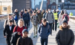 Commuters walk across London Bridge. The government has said it intends to lift all remaining Covid restrictions in England - including the legal rule to self-isolate - later this month. 