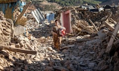 A woman walks past destroyed houses after an earthquake in the mountain village of Tafeghaghte, southwest of the city of Marrakesh, on September 9, 2023. Morocco's deadliest earthquake in decades has killed more than 2,000 people, authorities said on September 9, as troops and emergency services scrambled to reach remote mountain villages where casualties are still feared trapped. (Photo by FADEL SENNA / AFP) (Photo by FADEL SENNA/AFP via Getty Images)