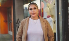 A 30-something Latina woman with frosted blond hair parted at the middle, wearing a tan blazer and white T-shirt. She looks relaxed head-on at the camera.