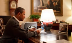 Barack Obama reading a letter at his desk in the White House