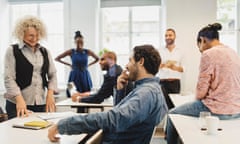 adult students and teacher laughing at an informal language class