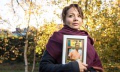 Taliya Frouza Savaheli holding a picture of her brother Reza.