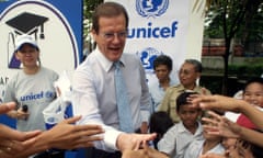 Roger Moore greets Indonesian schoolchildren during a visit to a Jakarta school on behalf of Unicef in 2001