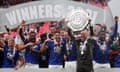 The Leicester players celebrate with the shield.