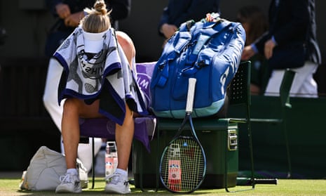 Britain's Harriet Dart covers her face with a towel during a break against China's Wang Xinyu
