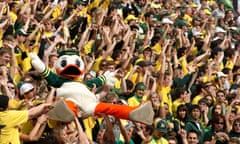 The Oregon Duck mascot is carried by the crowd at Autzen Stadium in Eugene, Oregon.