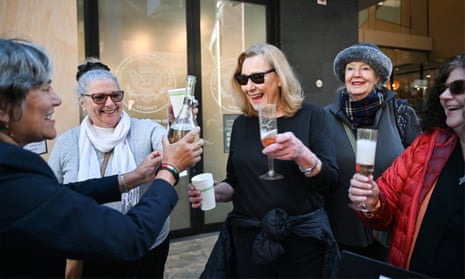 People celebrate together outside the consulate building.