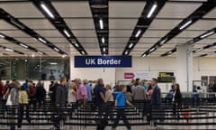 Border Force check the passports of passengers arriving at Gatwick Airport.