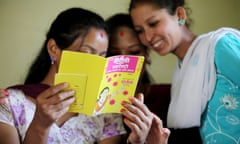 Young women read a leaflet about sex education and women's empowerment in Sankhu community clinic, Nepal.