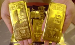 An employee shows gold bars at Shinhan Bank in Seoul