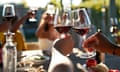 Friends toasting glasses with red wine in wedding party at winery on sunny day