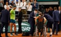 Alexander Zverev leaves the court in a wheelchair after suffering his injury as Rafael Nadal looks on.