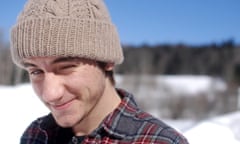 finn rooney, a young man in  a beanie hat and check shirt in a sunny snowy landscape, smiling