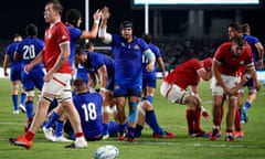 Italy’s Federico Zani celebrates with teammates scoring their sixth try.