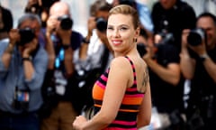 woman in orange and pink striped dress in front of photographers