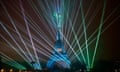 Shafts of light surround the Eiffel Tower during the Paris 2024 Olympics opening ceremony.