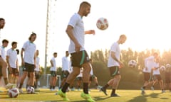 Aziz Behich of Australia controls the ball during an Australia Socceroos training session which his teammates in the background