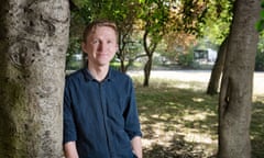 Writer Joe Dunthorne leaning against a tree in 2018. Photo by Linda Nylind.