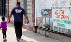 Suburban poverty is a result of the weak economy and people fleeing violence in cities like Chicago<br>HARVEY, IL - AUGUST 19: A sign painted on top of a mural says 'We accept food stamps,' on August 19, 2013 in Harvey, Illinois. Harvey is a depressed suburb of Chicago that has been hit even harder by the sluggish economy. The suburban poor also have challenges getting services that can help them. Buildings all over town are boarded up - whether they be single family homes or businesses. (Photo by Melanie Stetson Freeman/The Christian Science Monitor via Getty Images)