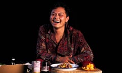 Khanh Ong, cook, author and TV host, sitting at a table with a plate of food and ingredients