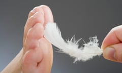 A foot being tickled with a feather.