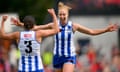 Isabella Eddey and Kate Shierlaw of North Melbourne celebrate a goal during the AFLW Qualifying Final against Melbourne at Ikon Park. 