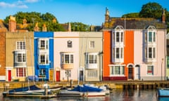 Colourful homes, quaint cottages in sunny fishing village harbour panorama in Weymouth, Dorset, UK.