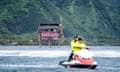 Officials ride a jet-ski during the Outerknown Tahiti Pro 2022 in Teahupo’o, French Polynesia with the old wooden tower in the background.