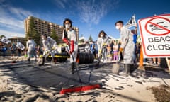 Hands Across the Sand protesters, Glenelg beach, South Australia: Protesters clean up a mock oil spill on the Glenelg beach as part of ‘Hands Across The Sand’, a series of coordinated protests targeting BP’s continuing push to drill for oil in the Great Australian Bight. BP’s plans were recently rejected by NOPSEMA, the regulatory body, for the second time. Taken on 21 May