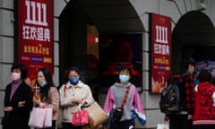 People walk along a main shopping area in Shanghai, China, during Alibaba's Singles Day shopping festival.